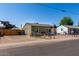 View of the exterior of the property with fence and gravel landscape at 1424 S Bonarden Ln, Tempe, AZ 85281