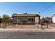 An exterior view of a single-Gathering home with a fenced yard and street view at 1424 S Bonarden Ln, Tempe, AZ 85281