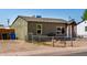 A street view of the grey painted home with gravel landscape and chain link fence at 1424 S Bonarden Ln, Tempe, AZ 85281