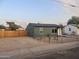 View of the exterior of the property with new wood fence and gravel landscape at 1424 S Bonarden Ln, Tempe, AZ 85281