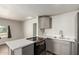 Modern kitchen featuring stainless steel appliances, gray cabinets, and white countertops at 1424 S Bonarden Ln, Tempe, AZ 85281