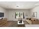 This virtually staged living room offers seating and is freshly painted with wood flooring at 1424 S Bonarden Ln, Tempe, AZ 85281