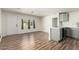 An empty living room flows into the kitchen and features new flooring and paint at 1424 S Bonarden Ln, Tempe, AZ 85281