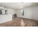 Open living space with wood floors, neutral walls, and stainless steel appliances visible at 1424 S Bonarden Ln, Tempe, AZ 85281