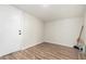 Neutral room with vinyl plank flooring and white door offers a versatile space at 1424 S Bonarden Ln, Tempe, AZ 85281