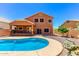 Home featuring a private pool, patio, and a well-maintained gravel area at 1690 E Desert Breeze Ct, Casa Grande, AZ 85122