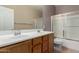 Bathroom with a double sink vanity, a large mirror, and a shower over tub with glass doors at 1690 E Desert Breeze Ct, Casa Grande, AZ 85122