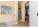 Bright bathroom features a soaking tub, glass shower, and an arched doorway to an adjacent room at 1690 E Desert Breeze Ct, Casa Grande, AZ 85122