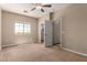 Spacious bedroom with a neutral color scheme, a ceiling fan, and a window letting in natural light at 1690 E Desert Breeze Ct, Casa Grande, AZ 85122
