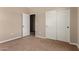 Bedroom features neutral walls and carpet, an open door and sliding closet doors at 1690 E Desert Breeze Ct, Casa Grande, AZ 85122