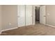 Bedroom features neutral carpet and trim, sliding closet doors and an open door to another room at 1690 E Desert Breeze Ct, Casa Grande, AZ 85122