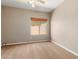 Neutral colored bedroom with neutral carpet, ceiling fan, and view to the rear yard at 1690 E Desert Breeze Ct, Casa Grande, AZ 85122