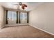 Large bedroom with carpet flooring, overhead fan, and three large windows for great light at 1690 E Desert Breeze Ct, Casa Grande, AZ 85122