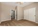Bedroom features neutral carpet, sliding closet doors and a view through the open door to the bathroom at 1690 E Desert Breeze Ct, Casa Grande, AZ 85122