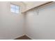 Bright walk-in closet featuring a window and ample storage space for organization at 1690 E Desert Breeze Ct, Casa Grande, AZ 85122