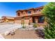 Two-story home featuring desert landscaping, a covered porch, and a three-car garage at 1690 E Desert Breeze Ct, Casa Grande, AZ 85122