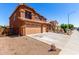 Side view of a desert-landscaped home showing a three-car garage and gravel yard at 1690 E Desert Breeze Ct, Casa Grande, AZ 85122