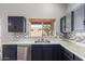 Spacious kitchen showcasing stainless steel appliances, expansive counters, and a sink with window at 1690 E Desert Breeze Ct, Casa Grande, AZ 85122
