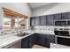 Well-lit kitchen offering stainless steel appliances, generous counters, and backsplash at 1690 E Desert Breeze Ct, Casa Grande, AZ 85122