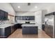 Stylish kitchen featuring stainless steel appliances, granite counters, and neutral tile flooring at 1690 E Desert Breeze Ct, Casa Grande, AZ 85122