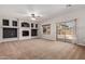 Large living room featuring a fireplace, built-in shelving, and a sliding glass door at 1690 E Desert Breeze Ct, Casa Grande, AZ 85122