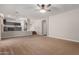 Spacious living room with neutral carpeting leading to the stairs and kitchen at 1690 E Desert Breeze Ct, Casa Grande, AZ 85122