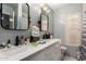 Bathroom featuring double sinks, quartz countertops, updated fixtures, and tiled walls and floors at 1736 E Villa Maria Dr, Phoenix, AZ 85022
