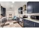 Modern kitchen features sleek countertops, updated appliances, and stylish navy cabinets for a contemporary feel at 1736 E Villa Maria Dr, Phoenix, AZ 85022