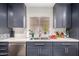 Contemporary kitchen with navy cabinets, stainless steel appliances, and updated fixtures at 1736 E Villa Maria Dr, Phoenix, AZ 85022