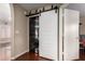 Laundry area with a sliding barn door that has a stackable washer and dryer at 1736 E Villa Maria Dr, Phoenix, AZ 85022