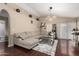 Comfortable living room features a plush gray sectional, modern lighting, and sleek wood flooring at 1736 E Villa Maria Dr, Phoenix, AZ 85022
