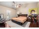 Bright main bedroom featuring a modern bed frame, ceiling fan, and access to an ensuite bathroom at 1736 E Villa Maria Dr, Phoenix, AZ 85022