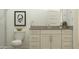 Bathroom featuring a toilet and vanity, with a framed artwork on the wall at 17551 W Victory St, Goodyear, AZ 85338