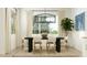 Bright dining room featuring a modern table, stylish chairs, and a large window with natural light at 17551 W Victory St, Goodyear, AZ 85338