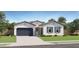 Inviting single-story home featuring a two-car garage and well-manicured lawn at 17551 W Victory St, Goodyear, AZ 85338