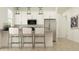 Bright kitchen features stainless steel appliances and barstool seating at the island at 17551 W Victory St, Goodyear, AZ 85338
