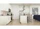 Modern kitchen with white cabinetry, stainless steel appliances, and an island with seating at 17551 W Victory St, Goodyear, AZ 85338