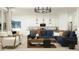Open-concept living room with stylish furnishings and seamless flow into the kitchen at 17551 W Victory St, Goodyear, AZ 85338