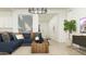 Bright living room featuring a comfortable blue sectional sofa and modern decor at 17551 W Victory St, Goodyear, AZ 85338