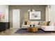 Comfortable living room with an L-shaped couch, coffee table, and entertainment center at 17551 W Victory St, Goodyear, AZ 85338