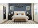Serene main bedroom featuring a king-size bed, stylish decor, and ample natural light at 17551 W Victory St, Goodyear, AZ 85338