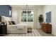 Inviting main bedroom with a king-size bed, accent wall, and large windows with natural light at 17551 W Victory St, Goodyear, AZ 85338