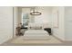 This stylish bedroom includes a light neutral palette, accent lighting, and a dedicated desk space at 17563 W Victory St, Goodyear, AZ 85338