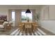 Open dining room area with a stylish table, a modern light fixture, and abundant natural light at 17563 W Victory St, Goodyear, AZ 85338