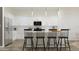 Bright kitchen with a central island, stainless steel appliances, and a view of the adjacent dining area at 17563 W Victory St, Goodyear, AZ 85338