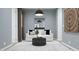 This stylish living room is painted a light blue and features a white sofa and plush rug at 17563 W Victory St, Goodyear, AZ 85338