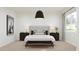 Stylish main bedroom with a light gray upholstered bed frame, side tables, lamps, and a bench at 17563 W Victory St, Goodyear, AZ 85338