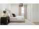 Bright and airy bedroom with a light gray upholstered bed frame and closet at 17563 W Victory St, Goodyear, AZ 85338