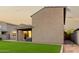 The backyard features an artificial turf lawn, brick-lined edges, and an exterior view of the home with a jacuzzi at 17813 W Pinnacle Vista Dr, Surprise, AZ 85387