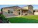 The backyard features a cozy covered patio area, artificial turf and a convenient hot tub at 17813 W Pinnacle Vista Dr, Surprise, AZ 85387